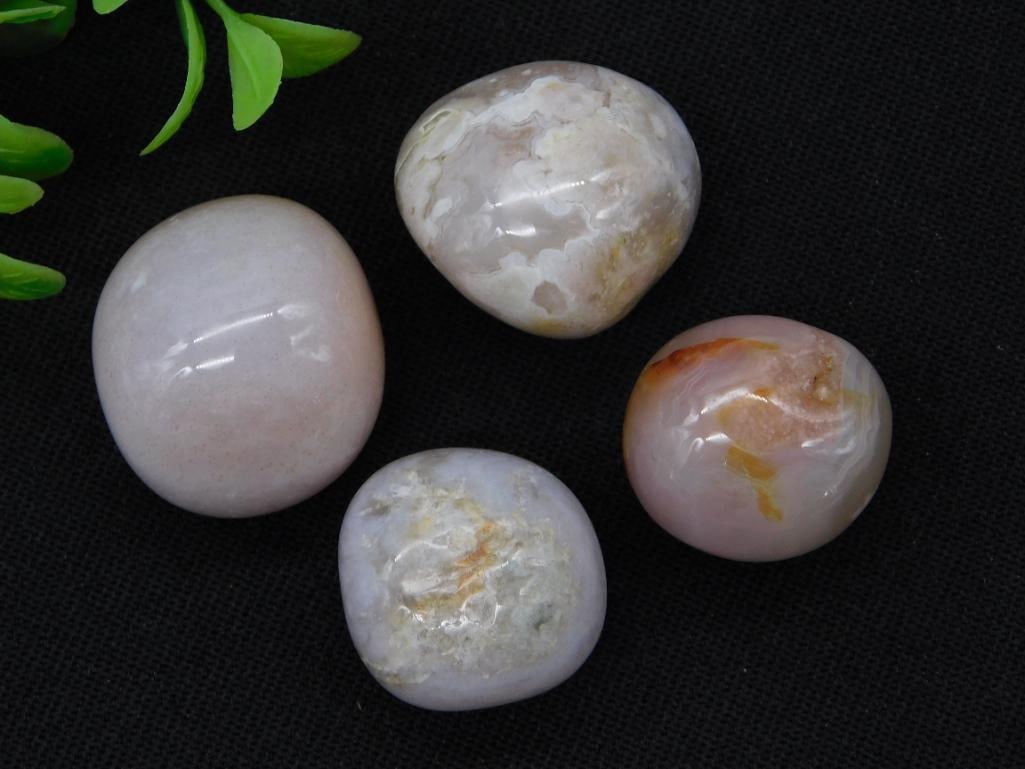 Polished Agate Mineral Stone Set: Four smooth, tumble-polished agate stones in cream, blush pink, and banded white-orange tones. 76 grams total.