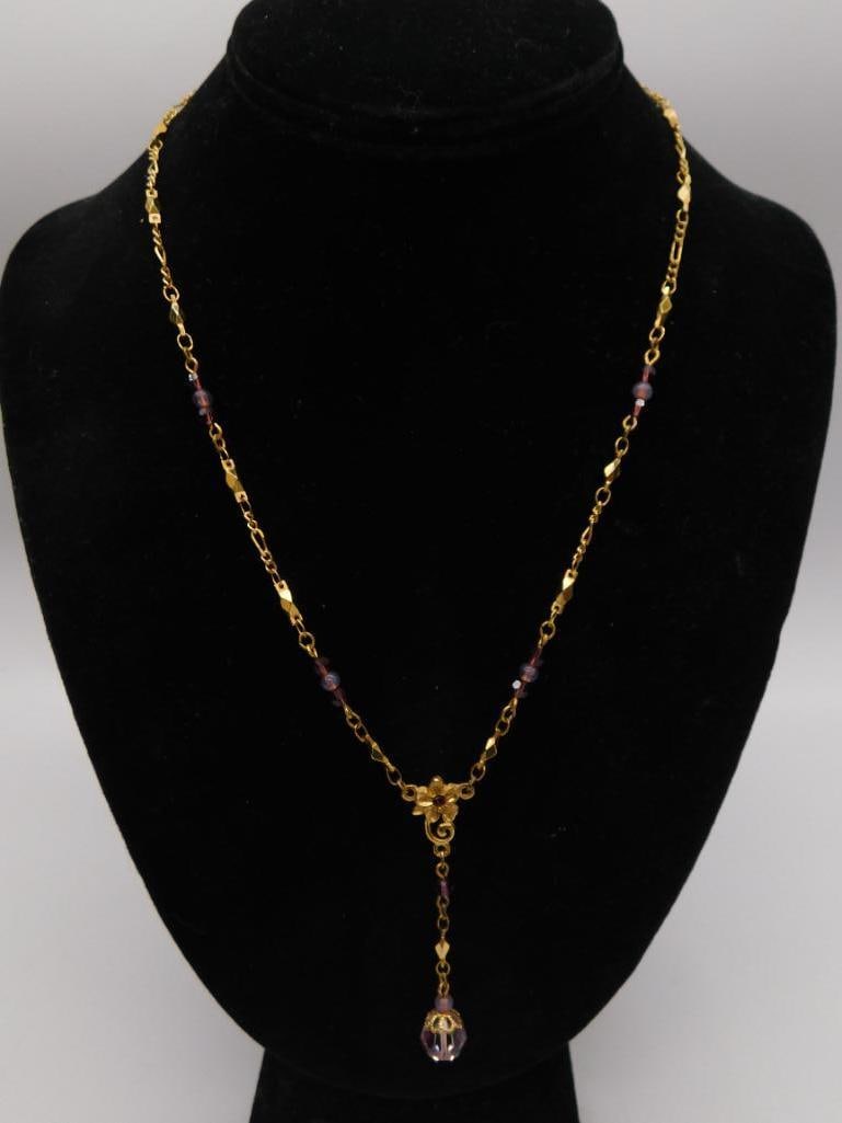 Gold-Tone Amethyst Bead Necklace, 1928 Brand Vintage Jewelry: Vintage gold-tone chain necklace by 1928 Jewelry Co. with small round purple glass beads spaced along diamond-cut links, a floral connector set with a purple rhinestone, and a faceted purple glass dro