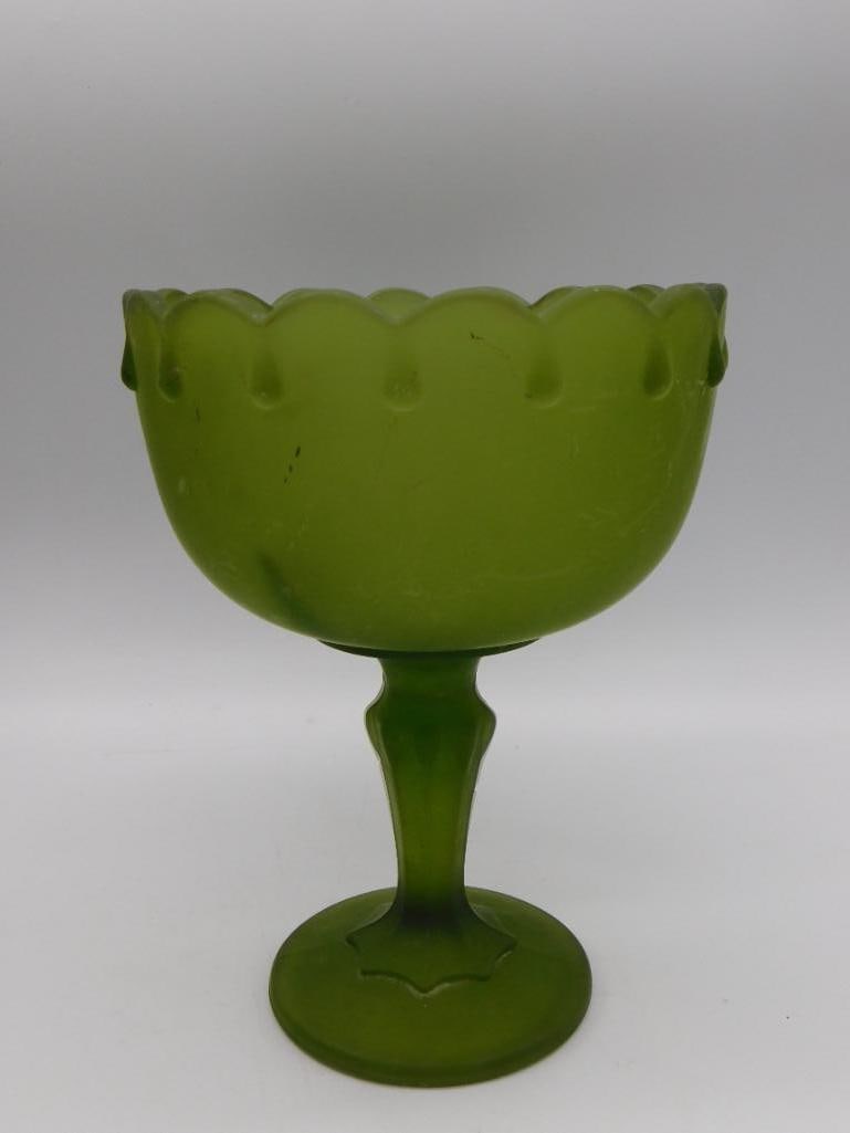 Green Satin Glass Pedestal Compote Dish: Frosted green satin glass footed compote/candy dish with a scalloped, ruffled rim. Approximately 7 inches tall.