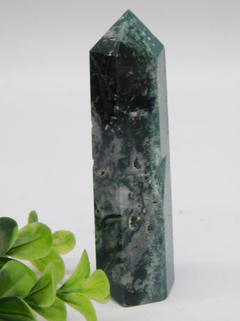 Rock Specimen Moss Agate Polished Obelisk: Polished moss agate tower/obelisk point with dark green and white banded inclusions. Weighs approximately 90 grams.