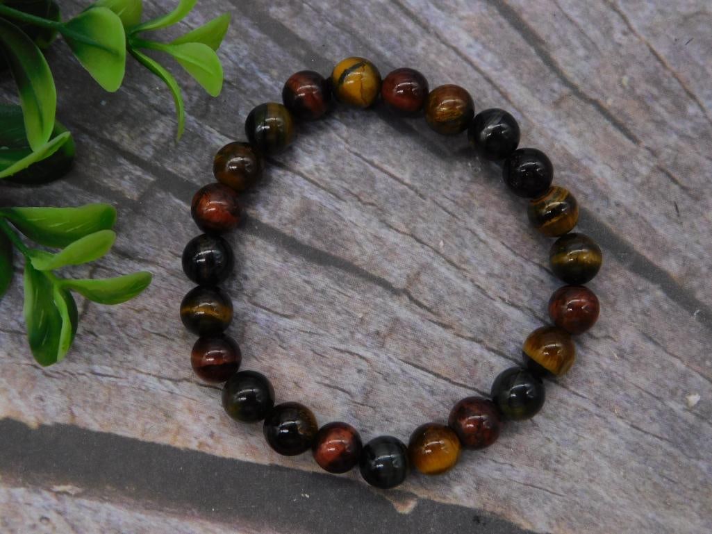 Tiger's Eye Beaded Stretch Bracelet: Beaded bracelet strung with round polished tiger's eye stones in mixed red, black, and golden-brown hues, elastic stretch style.