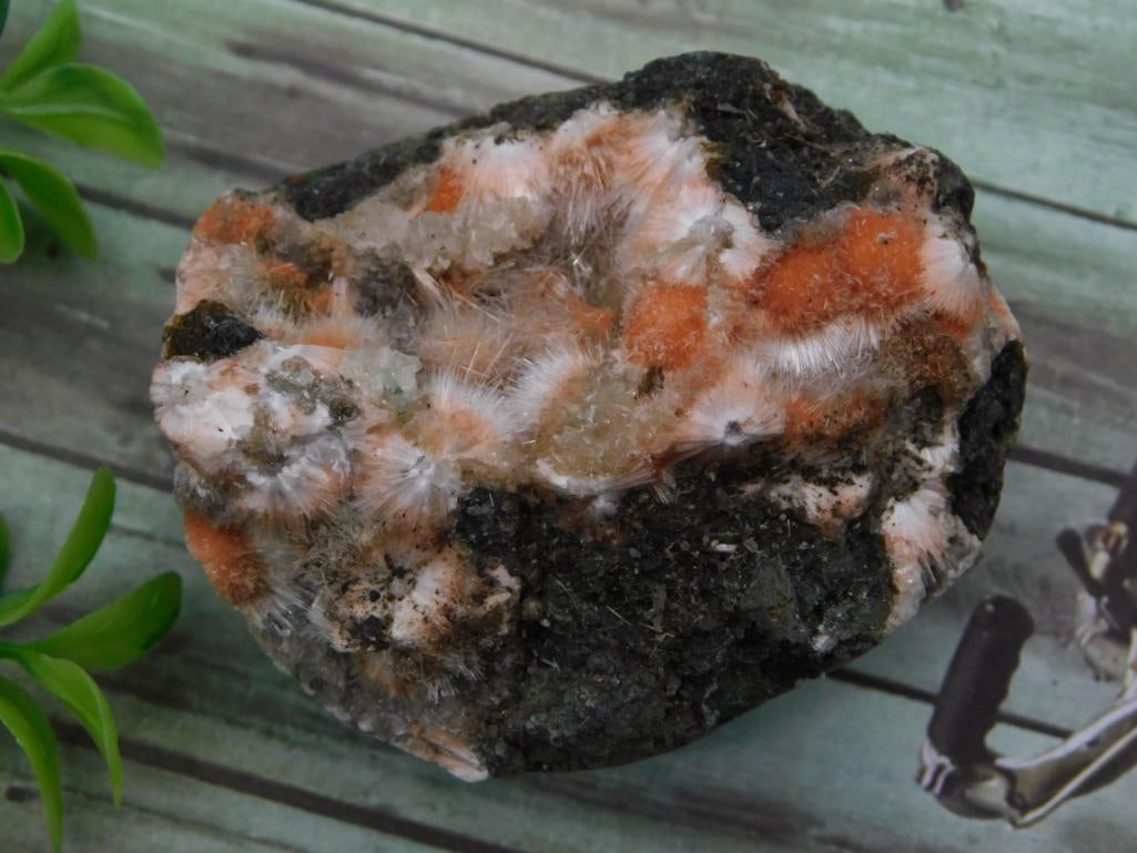 Orange Calcite and White Zeolite Mineral Specimen: Rough mineral specimen with radiating white zeolite crystal clusters and orange calcite inclusions on a dark matrix base, 89 grams.