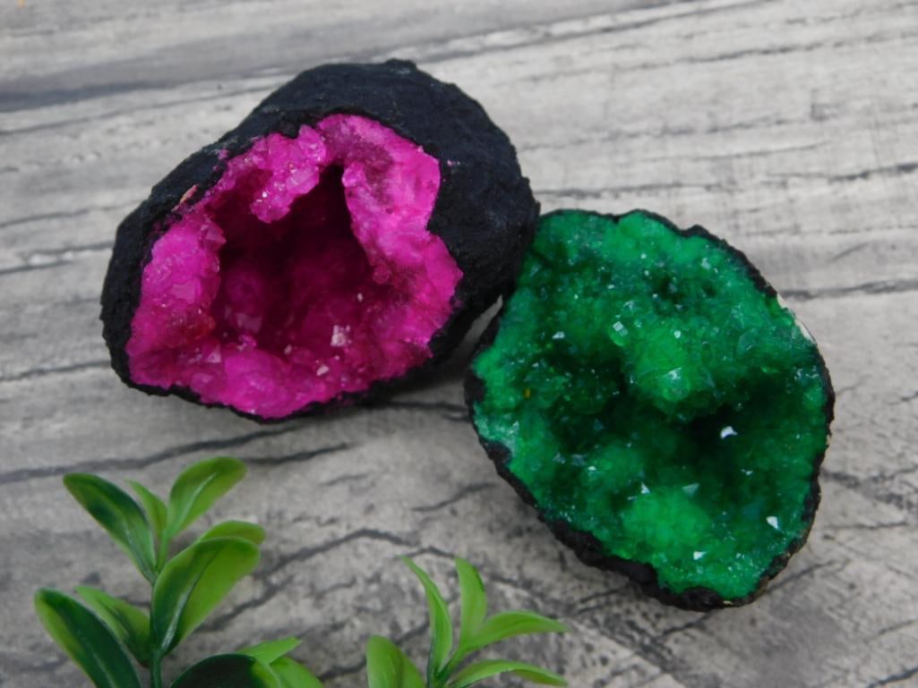 Pink Cobaltoan Calcite and Green Crystal Geode Pair: Pair of split geodes, one lined with vivid pink cobaltoan calcite crystals and the other with green crystal formations, 128 grams total.