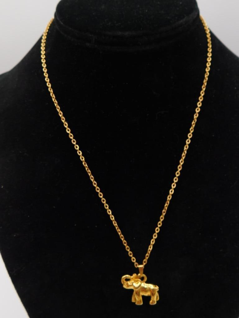 Gold-Tone Elephant Pendant Necklace: Delicate gold-tone chain necklace with a small standing elephant charm pendant.