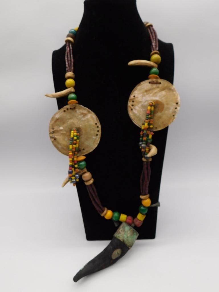 Tribal Bone and Trade Bead Necklace: Ethnic style necklace with carved bone disc pendants, horn pendant, and multicolor trade beads.