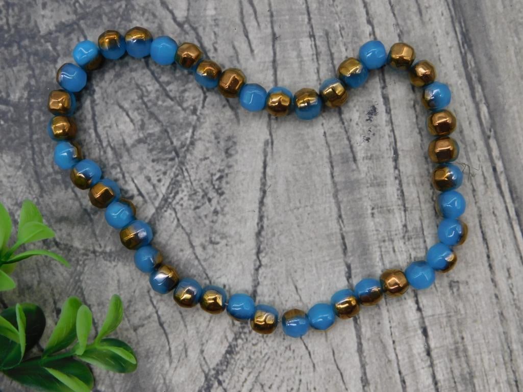 Blue and Gold Bead Stretch Bracelet: Faceted blue and gold-tone hematite bead stretch bracelet.