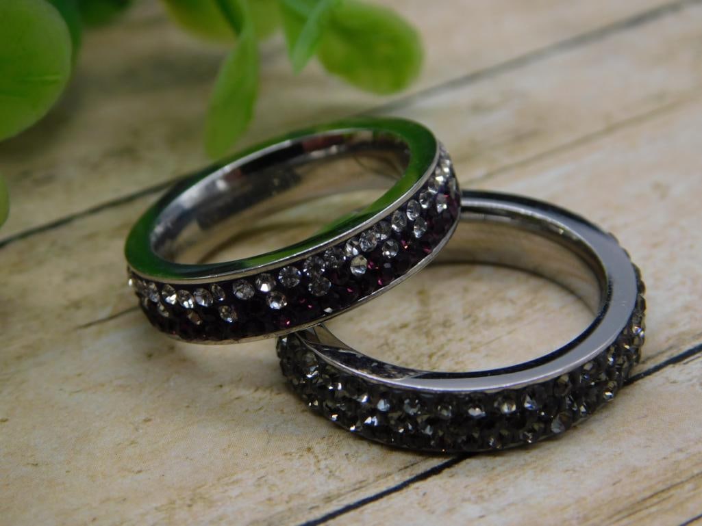 Rhinestone Eternity Band Ring Pair: Pair of sparkly rhinestone-encrusted eternity band rings in silver and gunmetal tones.