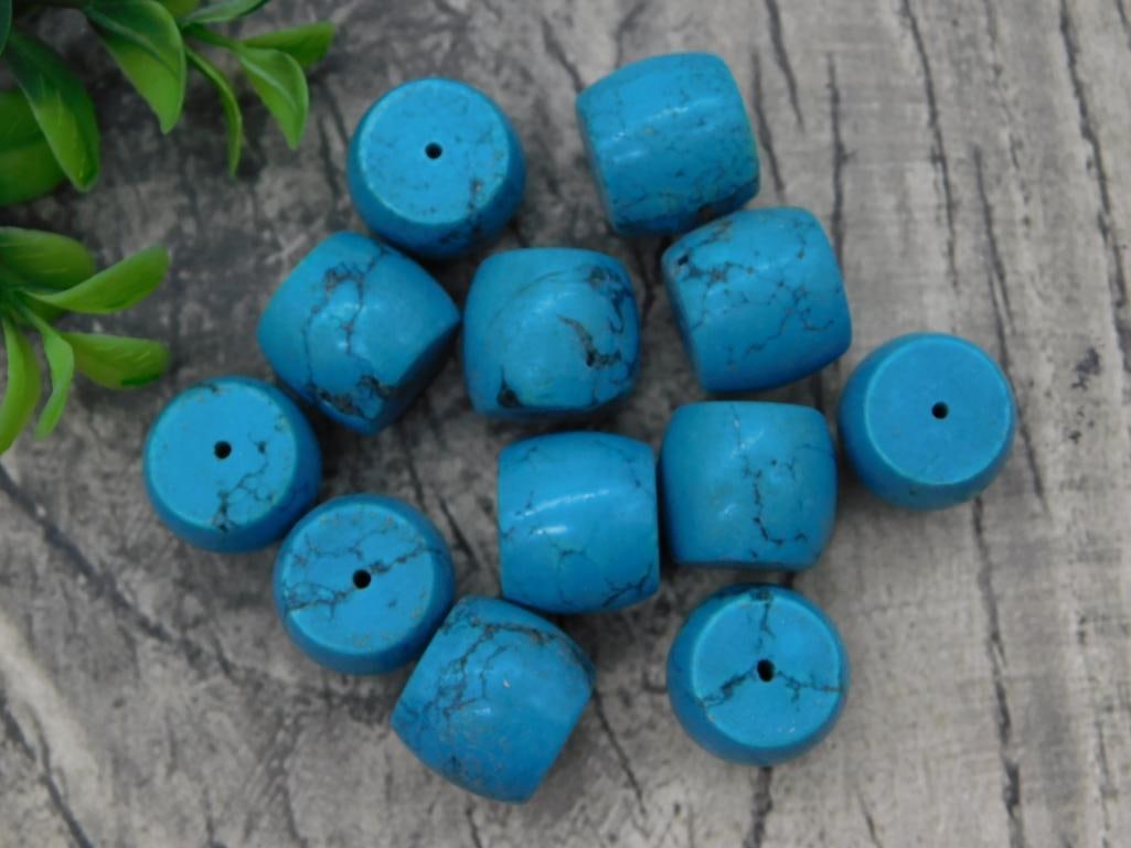 Turquoise Barrel Bead Lot: Group of approximately eleven drilled turquoise-colored barrel-shaped beads for jewelry making.