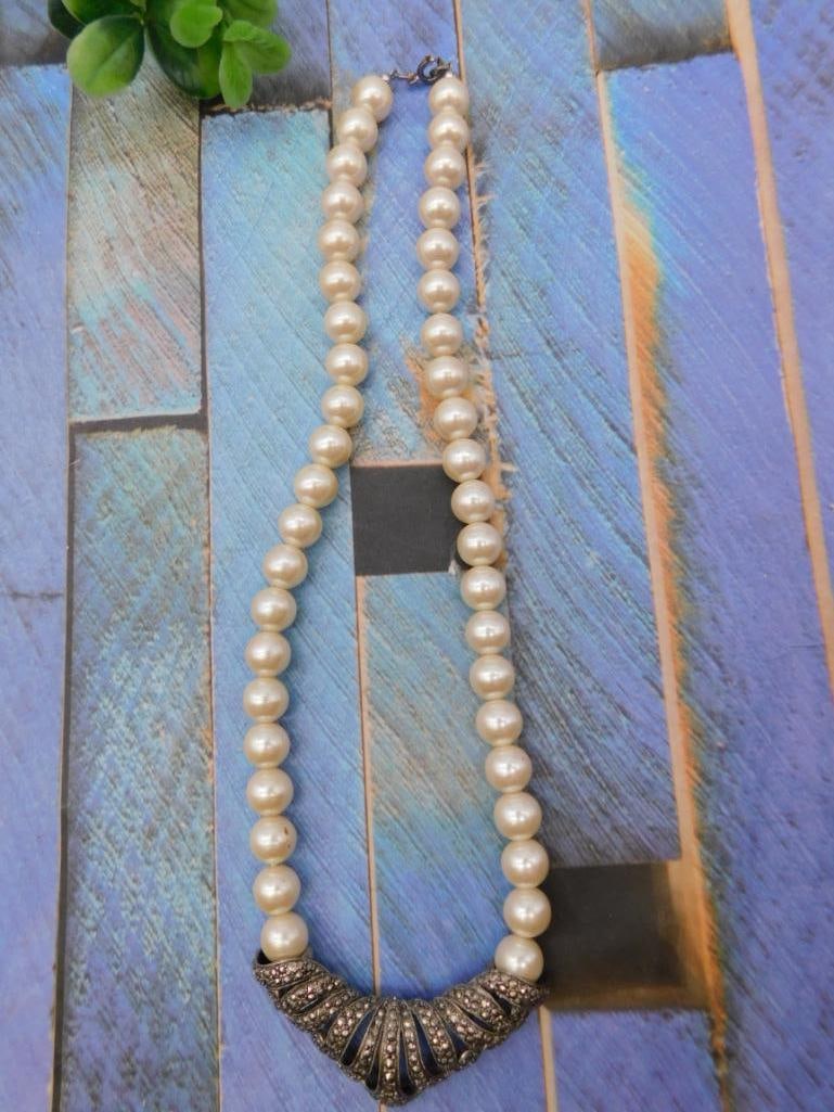 Faux Pearl Necklace with Marcasite Pendant: Strand of round faux pearls finished with an Art Deco style marcasite-set pendant clasp.