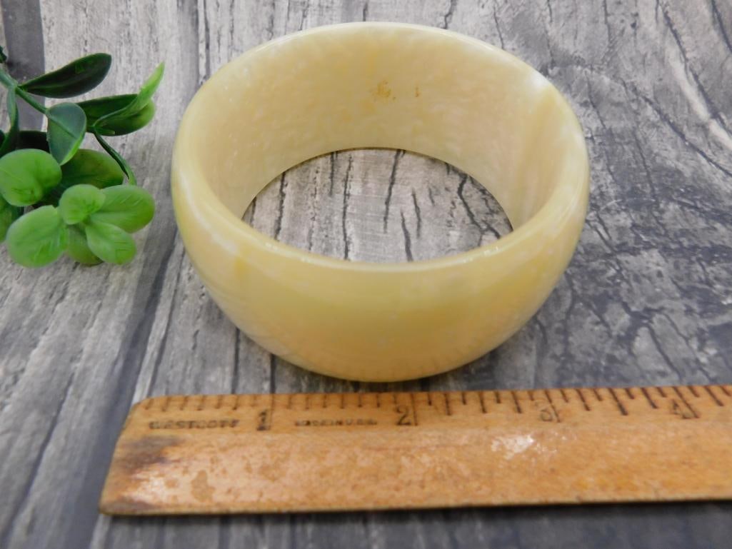 Carved Onyx Bangle Bracelet: Wide polished cream/tan stone bangle bracelet, likely onyx or agate, approx 3 inches diameter.