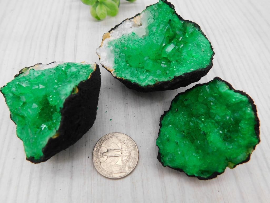Dyed Green Crystal Geode Slices (Set of 3): Three dyed emerald-green druzy crystal geode halves with dark rock matrix border.