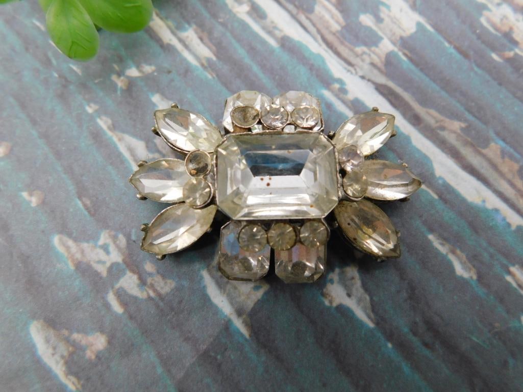 Vintage Rhinestone Brooch: Silver-tone floral rhinestone brooch with emerald-cut center stone and marquise accents.