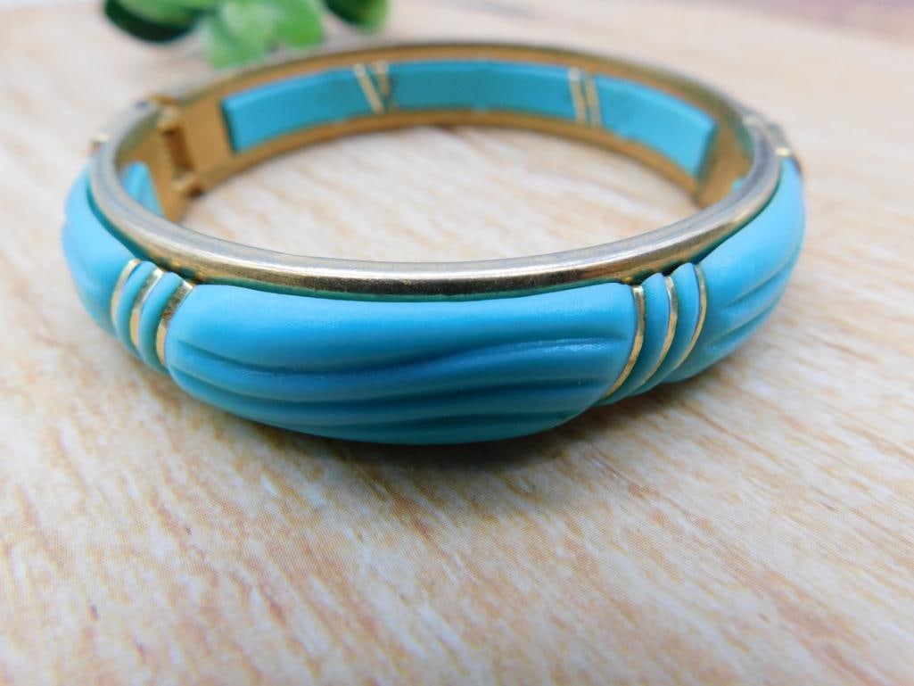 Turquoise Enamel Bangle Bracelet: Wide gold-tone bangle bracelet with sculpted turquoise-blue enamel wave design.