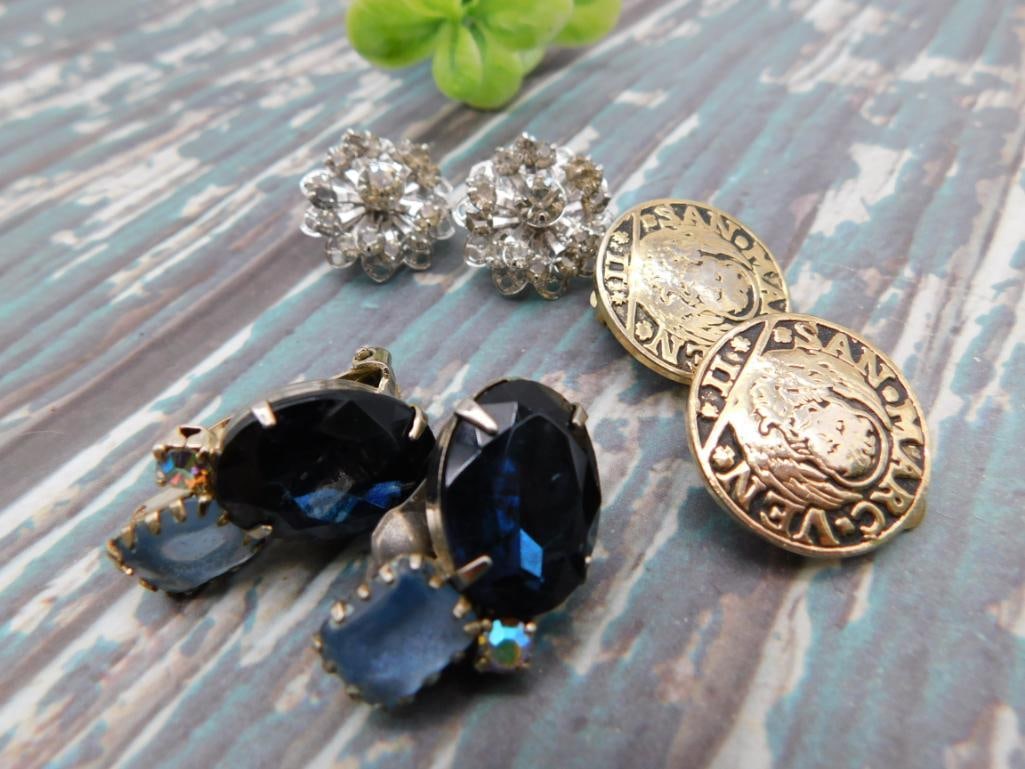 Vintage Rhinestone Earrings and Coin Button Lot: Mixed jewelry lot including clear rhinestone cluster earrings, blue faceted glass earrings, and two Venetian-style coin buttons.