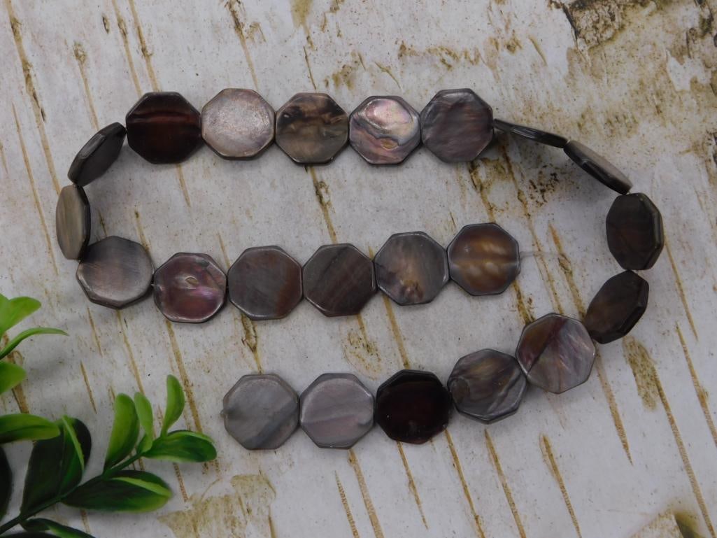 Mother of Pearl Shell Bead Bracelet: Faceted mother of pearl shell disc bead bracelet in gray and iridescent tones.