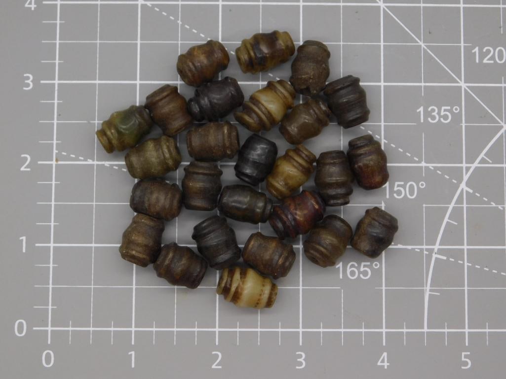 Wood Barrel Bead Lot: Approximately 25 carved wooden barrel/ribbed-shape beads in varied brown, olive, and one cream-and-red banded tone, weighing 91 grams total. Each bead is drilled for stringing and shows hand-turned ri