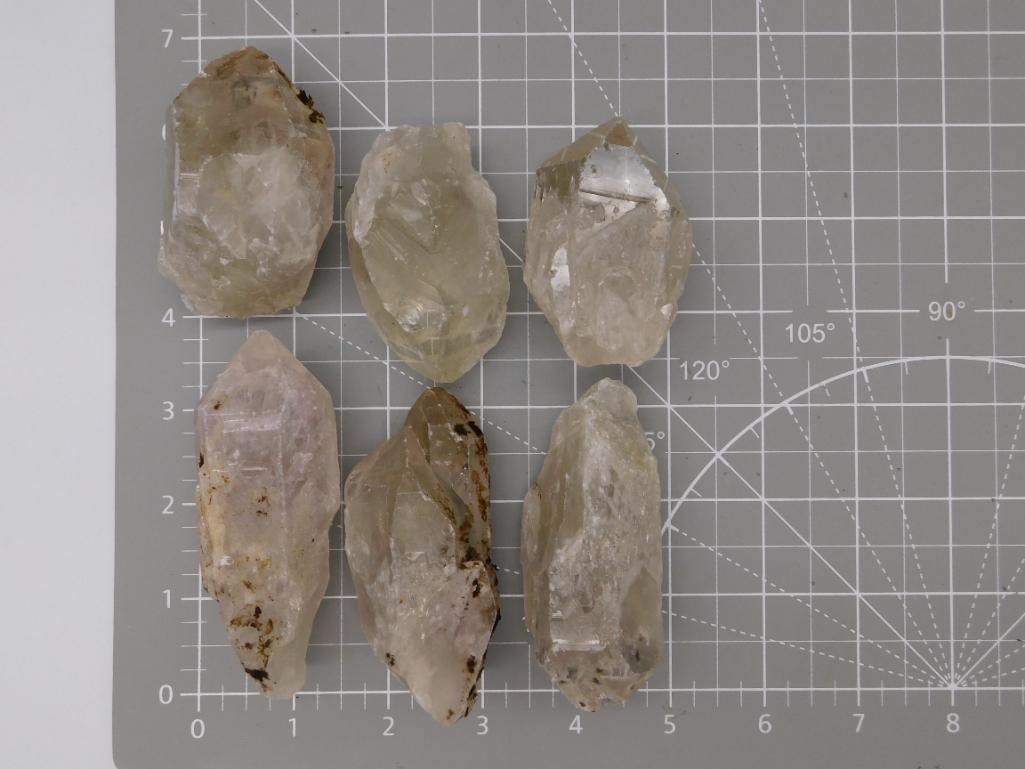 Mineral Smoky and Citrine Quartz Crystal Points Lot: A lot of six natural quartz crystal points in smoky gray, pale citrine, and clear tones, each with well-formed terminations and some iron-oxide surface staining. Crystals range roughly 2 to 3 inches i