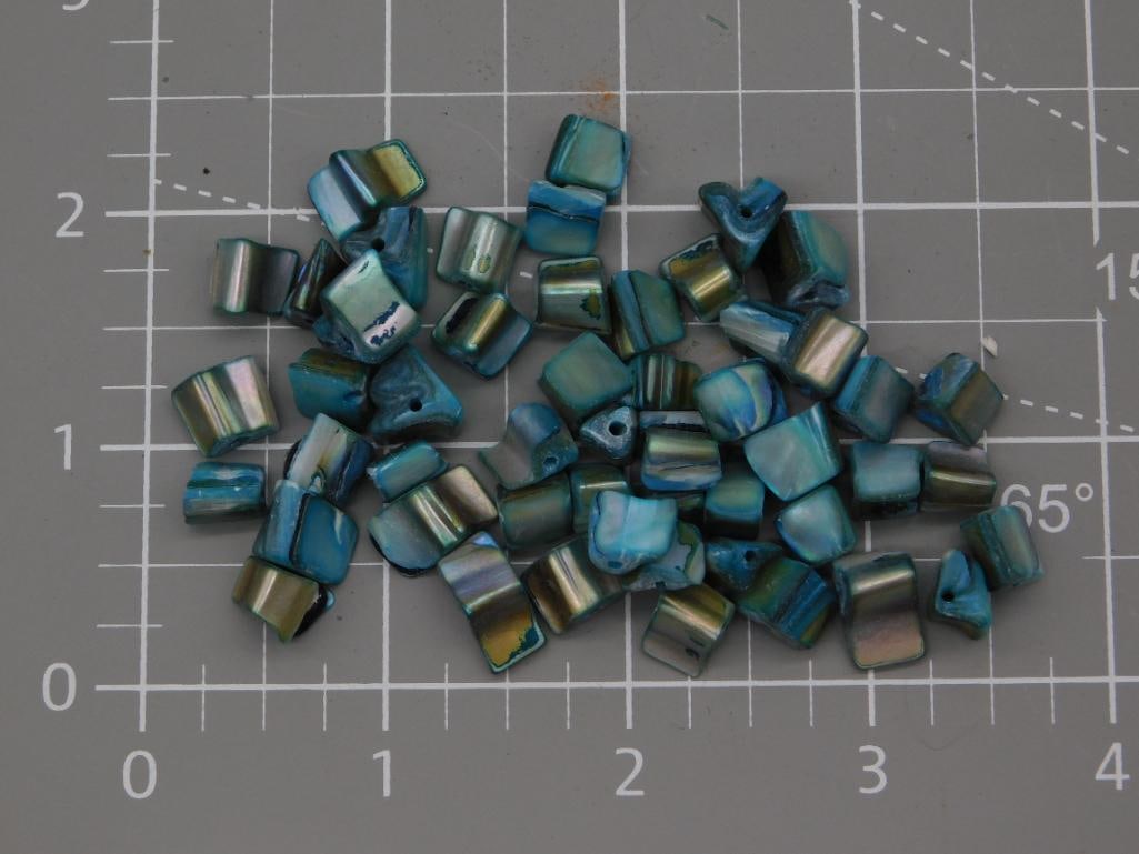 Jewelry Iridescent Paua Shell Chip Bead Lot: A quantity of small drilled iridescent shell chip beads in blue-green, teal, and bronze tones, likely paua or abalone shell, suitable for jewelry stringing. Beads average roughly 1/4 to 1/2 inch, show