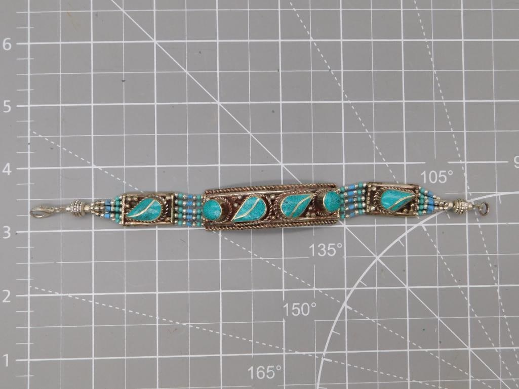 Turquoise Inlay Link Bracelet, Tibetan Style: A silver-tone metal link bracelet set with four oval turquoise cabochons framed by ornate rope-twist borders and rows of tiny blue and turquoise seed beads, in a Tibetan/Nepalese ethnic jewelry style.