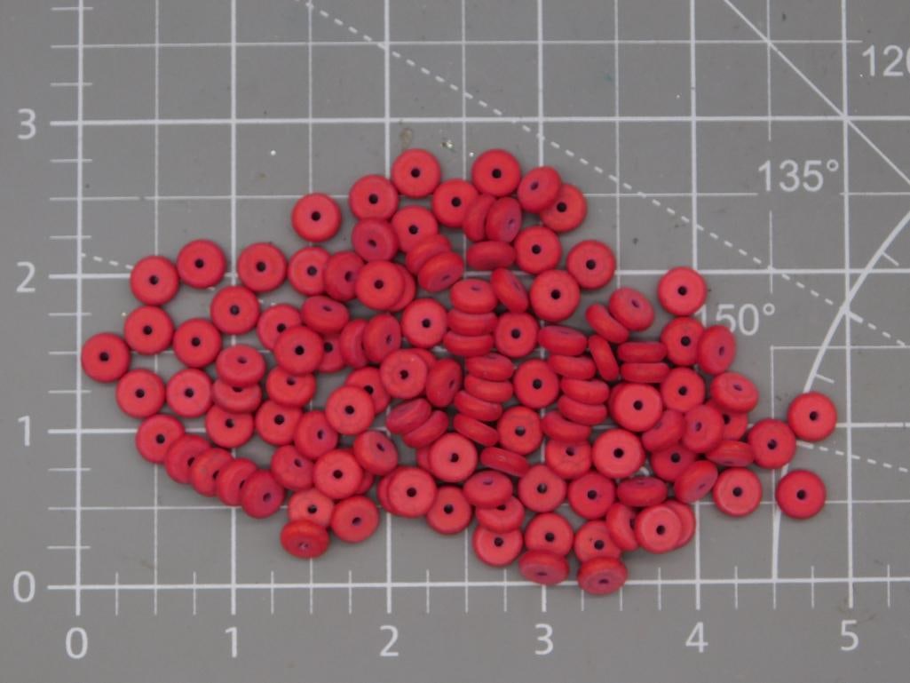Red Disc Bead Lot: Large lot of small red flat disc/rondelle beads, each approximately 6-7mm diameter, shown on a ruled mat. Total weight labeled 40 grams. Part of the 2026 Rock Auction.