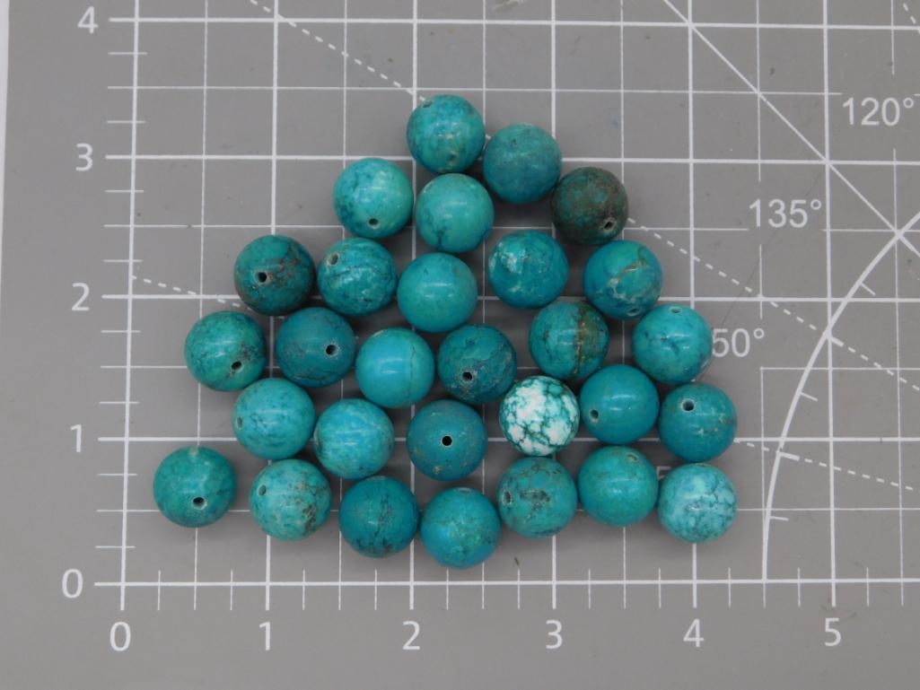 Turquoise Round Bead Lot: Large strand of round turquoise beads in blue-green tones with natural matrix veining and one white/black accent bead, each approximately 8mm, shown on a ruled mat. Total weight labeled 113 grams.