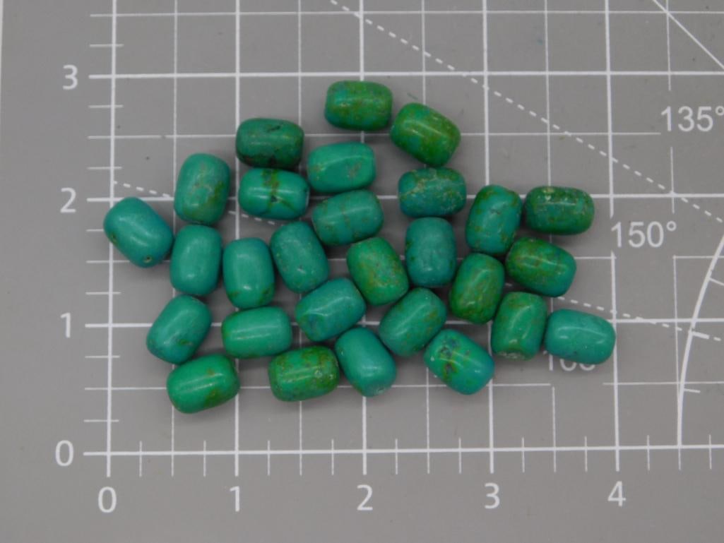 Turquoise-Style Oval Bead Lot: Loose strand of oval beads in turquoise blue-green with natural matrix spotting, each approximately 9mm, shown on a ruled mat. Total weight labeled 66 grams. Part of the 2026 Rock Auction.