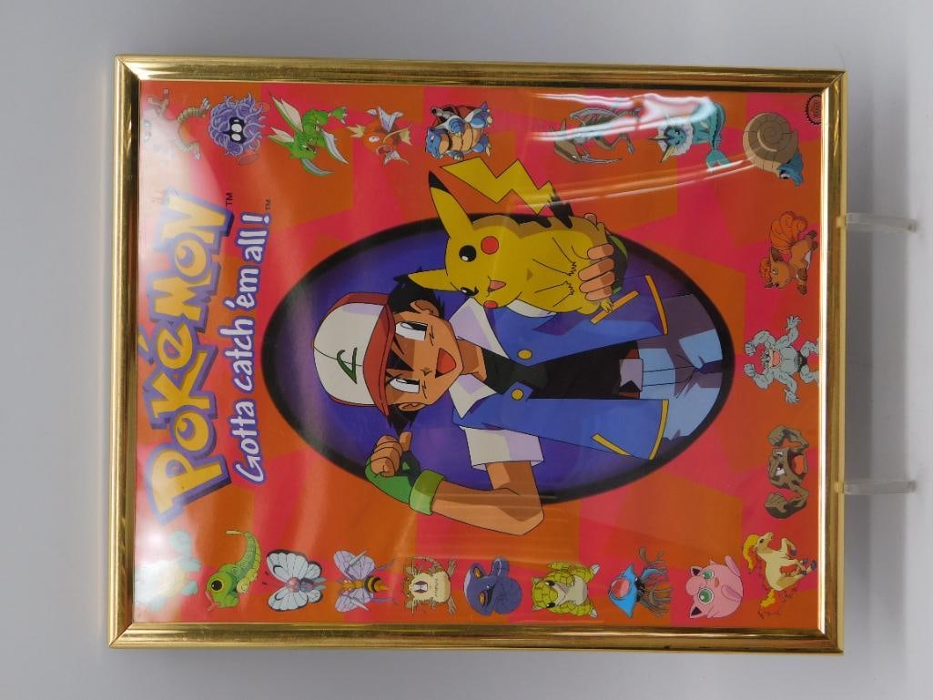 Pokemon 'Gotta Catch 'Em All' Framed Poster - Gold Frame: A framed Pokemon promotional print featuring Ash Ketchum and Pikachu at center surrounded by various original 151 Pokemon characters on an orange background. Housed in a gold-tone frame measuring
