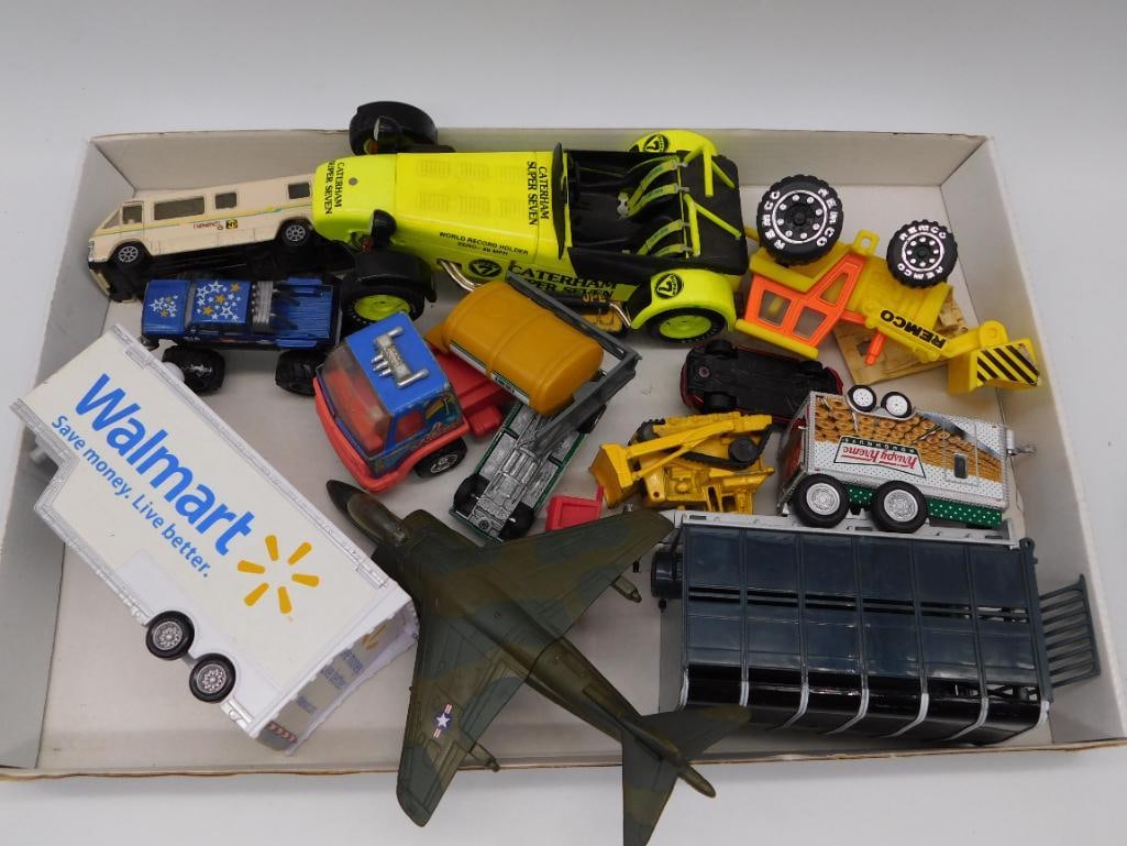 Vintage Diecast and Plastic Toy Vehicle Lot (Walmart Trailer, Caterham, Airplane, and More): A mixed lot of vintage die-cast and plastic toy vehicles including a Remco crane, a Caterham Super Seven race car, a Walmart semi-trailer, a camouflage military jet, a Hershey's delivery truck, a
