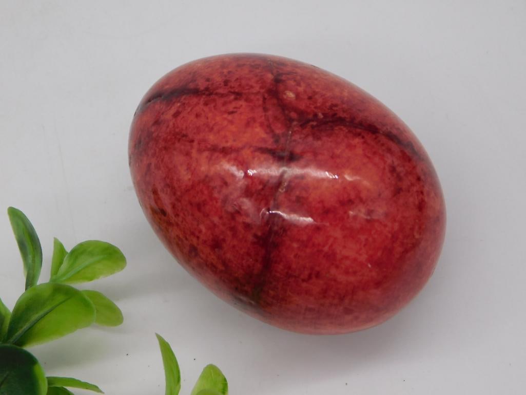 Polished Red Jasper Egg - Natural Stone Decorative Egg: A polished red and burgundy mottled jasper egg with natural veining and a glossy finish, egg-shaped decorative stone. Approximately 2.5 inches tall, shown with a 1966 Washington quarter and the
