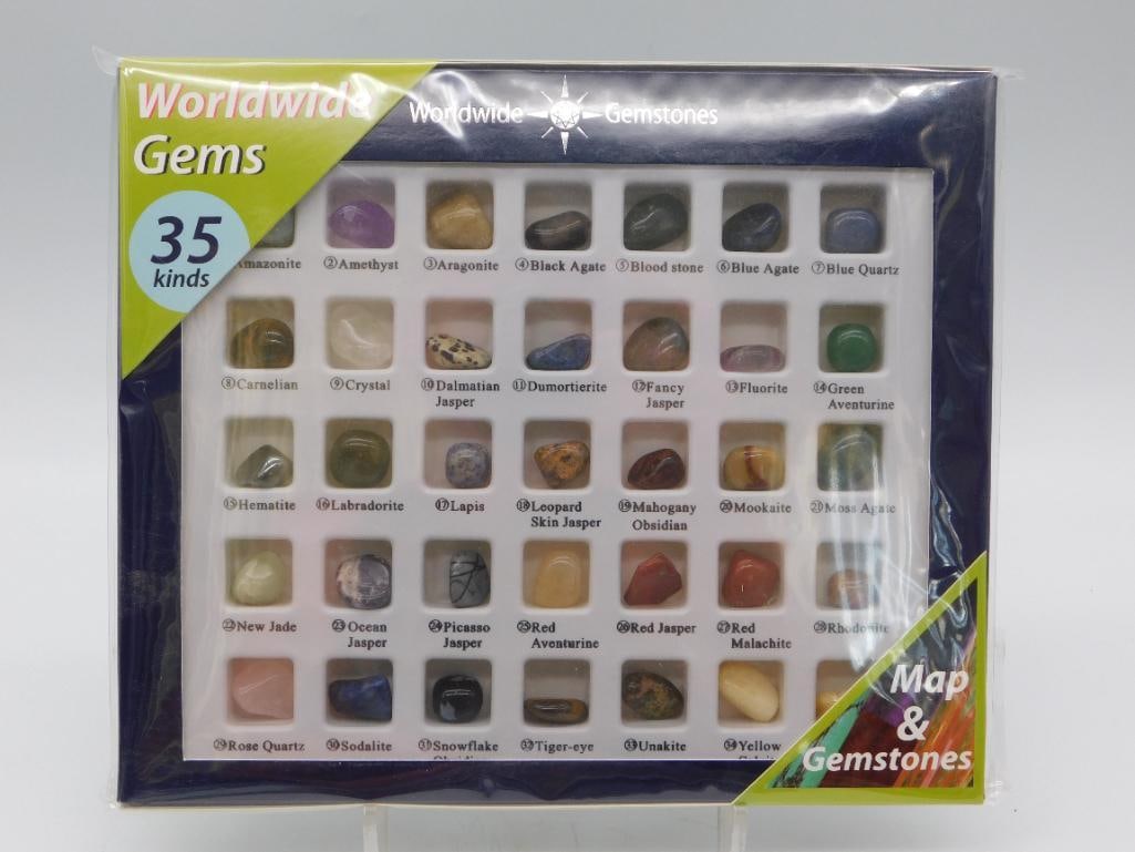 Worldwide Gemstones '35 Kinds' Tumbled Stone & Map Collection, Sealed: Factory-sealed educational display box containing 35 different types of tumbled polished gemstones including amethyst, tiger's-eye, sodalite, rose quartz, and lapis, each labeled with name and paired