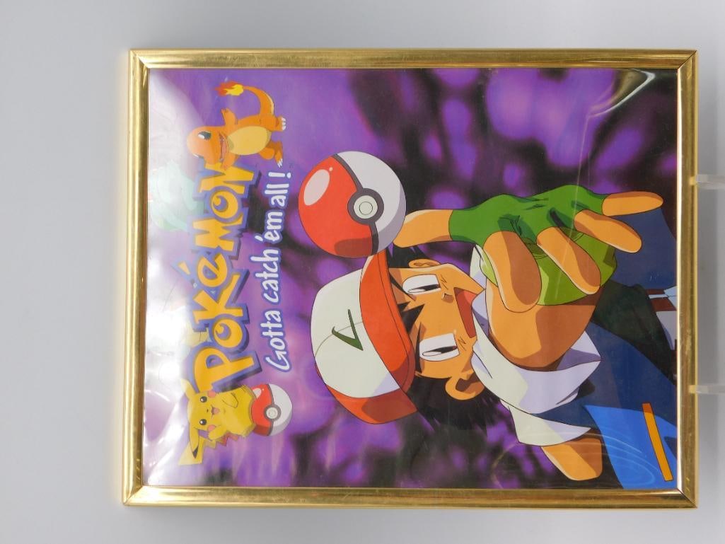 Framed Pokemon Gotta Catch 'Em All Poster: Framed Pokemon promotional print in a gold-tone frame featuring Ash Ketchum reaching for a Poke Ball with Pikachu, Charmander, Squirtle, and Bulbasaur artwork, and the slogan "Gotta catch 'em all!"
