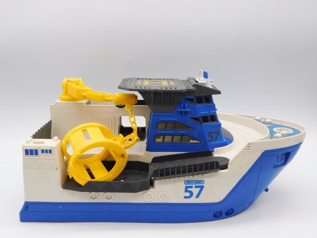 Matchbox 57 Toy Rescue Ship with Fists of Steel WWII Book: Lot combines a blue and white Matchbox #57 plastic toy salvage/rescue boat with a working yellow crane and grappling claw, and a hardcover Time-Life "Fists of Steel" volume from The Third Reich series