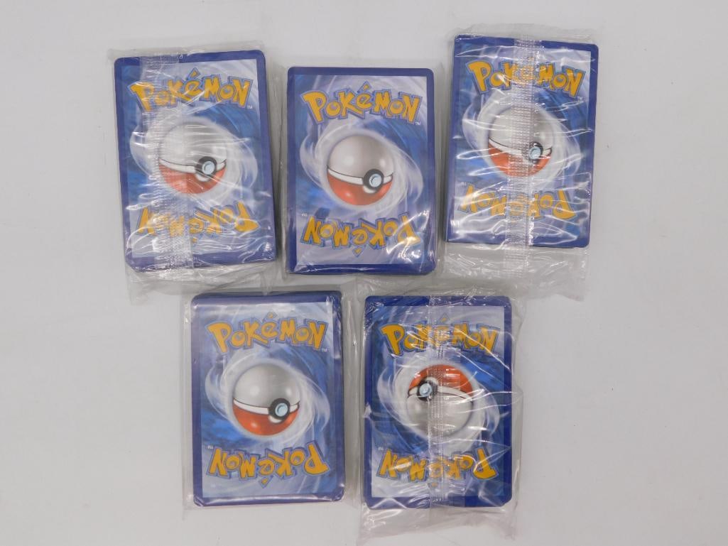 Toy - Lot of Loose Pokemon Trading Cards with Energy Cards: A grouping of ten Pokemon trading cards, including five card-back-facing cards in individual plastic sleeves and five Basic Energy cards (Water, Lightning, Fire, Darkness, and Fighting/Fire types) sho