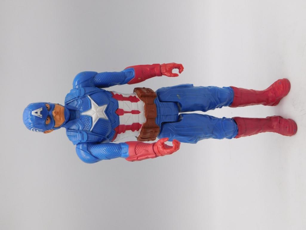 Captain America Marvel Hasbro Action Figure: A 2018 Hasbro/Marvel Captain America poseable action figure in blue suit with red boots and gloves and shield-emblem chest star. Approximately 12 inches tall, as shown against a Westcott ruler. Boot s