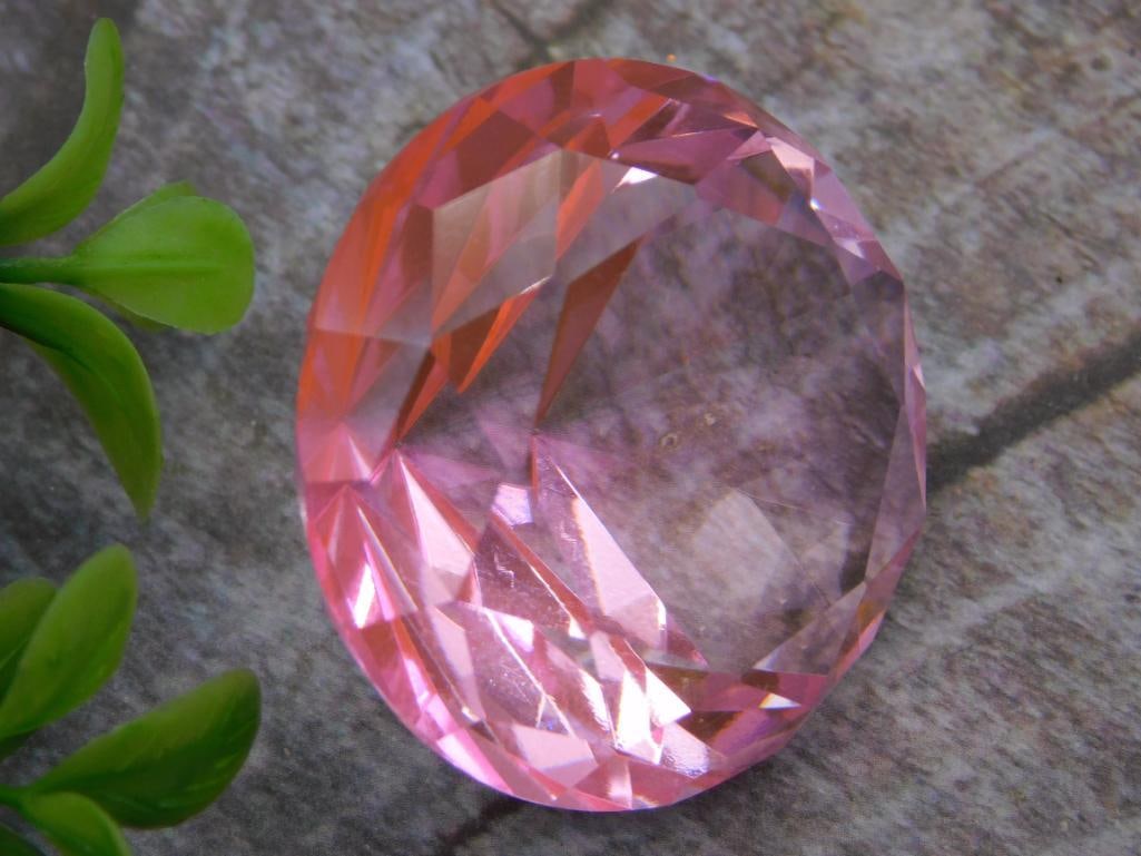 Crystal: Pink Faceted Round Glass Gemstone Paperweight: Large round faceted pink glass gemstone-form decorative piece, cut in a brilliant style with multiple triangular facets, approximately 1.5-2 inches in diameter. Likely a decorative crystal