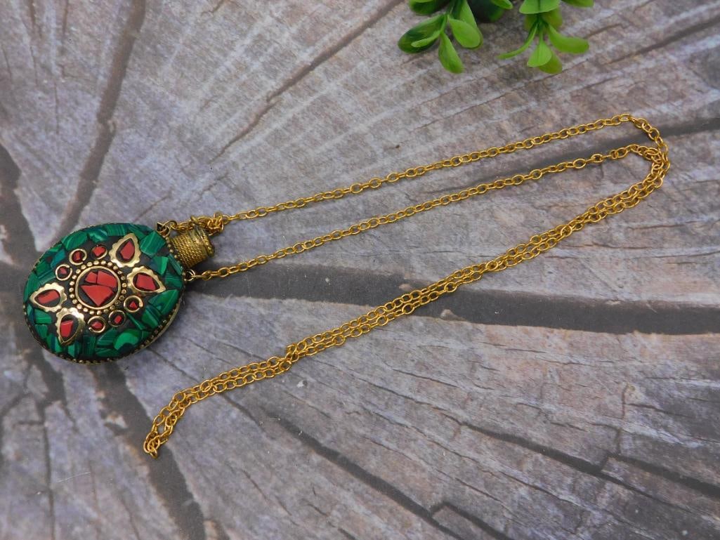 Pendant Necklace: Malachite and Coral Inlay Medallion on Brass Chain: Round pendant necklace featuring green malachite chip inlay accented with red coral-style cabochons set in a brass/bronze-tone floral medallion design, likely Tibetan or Nepalese in style. Suspended o