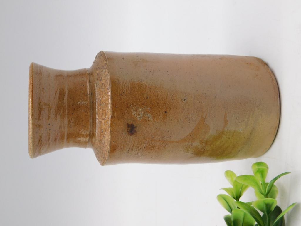 Antique Pottery: Brown Salt-Glazed Stoneware Jug: Utilitarian brown salt-glazed stoneware jug or crock with a flared neck and cylindrical body, approximately 8-9 inches tall. Surface shows a mottled amber-to-olive glaze with drip variations typical o