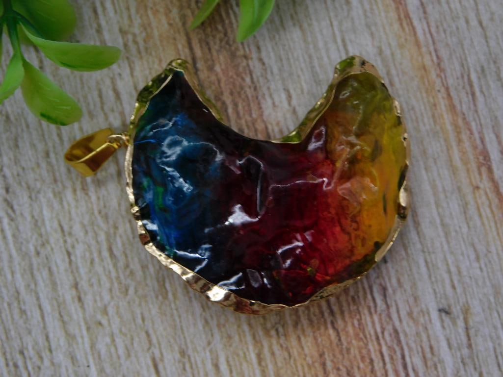Art Glass Cabochon Pendant - Multicolor Enamel Drip in Gold-Tone Bezel: A crescent/heart-shaped pendant featuring a swirled multicolor art glass or resin cabochon in blue, red, and amber tones, set in a hammered gold-tone bezel with bail. Measures roughly 1.5 inches wide,