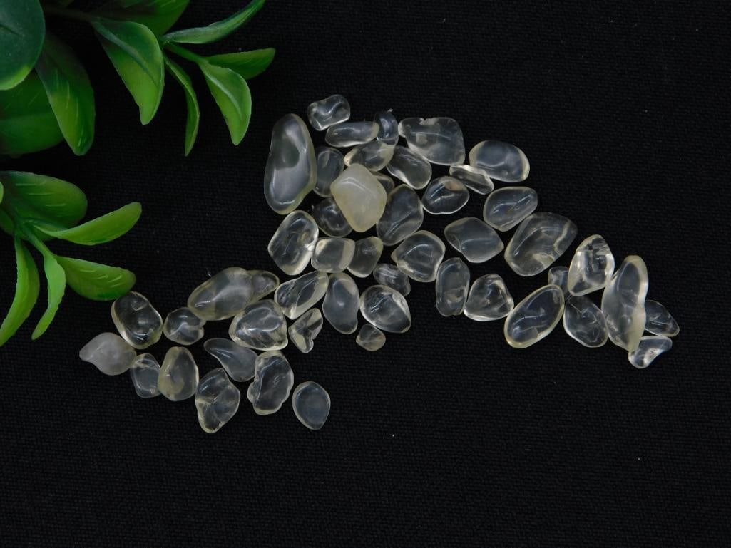 Lemon Quartz Tumbled Stone Lot - 12 Grams: A small lot of tumbled lemon quartz crystal chips weighing 12 grams, mostly clear with pale yellow tints. Pieces are small, ranging up to roughly an inch, shown beside a quarter for scale. Sold as