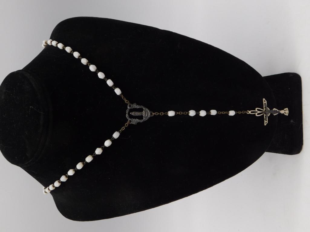 Antique Sterling Silver Crucifix Rosary with White Glass Beads: An antique rosary featuring faceted milk-white glass beads on a dark metal chain, with an ornate sterling silver crucifix pendant and a separate devotional medal link, marked "STG" (sterling) on the c