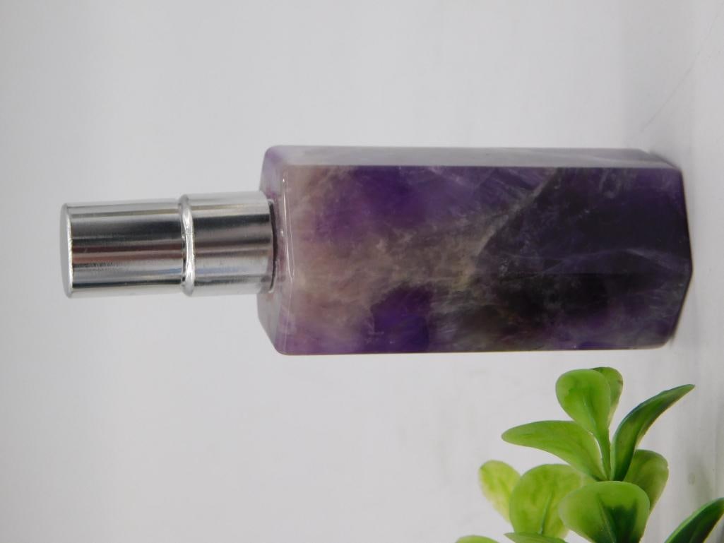 Amethyst Crystal Perfume Atomizer Bottle: Carved amethyst crystal perfume bottle with a faceted rectangular body and chrome-tone atomizer spray top, weighing approximately 28 grams per the lot tag. The stone displays rich purple and smoky