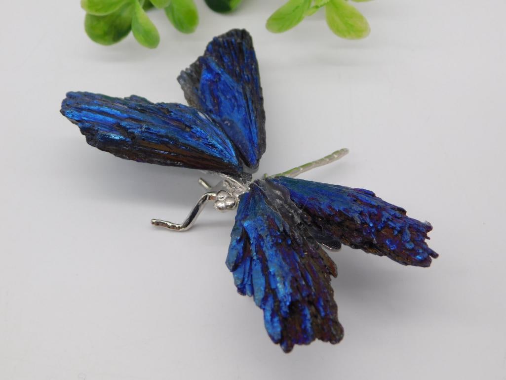 Mineral Specimen - Chalcopyrite Bornite Peacock Ore Butterfly Carving: A decorative butterfly figure crafted from iridescent blue-purple chalcopyrite (peacock ore) mineral slices mounted on a silver-tone wire body with formed legs and antennae. Measures approximately 3