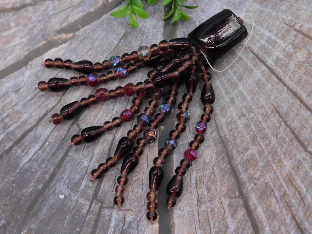 Vintage Beaded Tassel Pendant with Iridescent Glass Beads: Handmade beaded tassel ornament featuring dark amber and garnet-tone glass beads with iridescent AB accent beads, capped by a large lacquered wood bead top with hanging cord. Measures approximately 6 