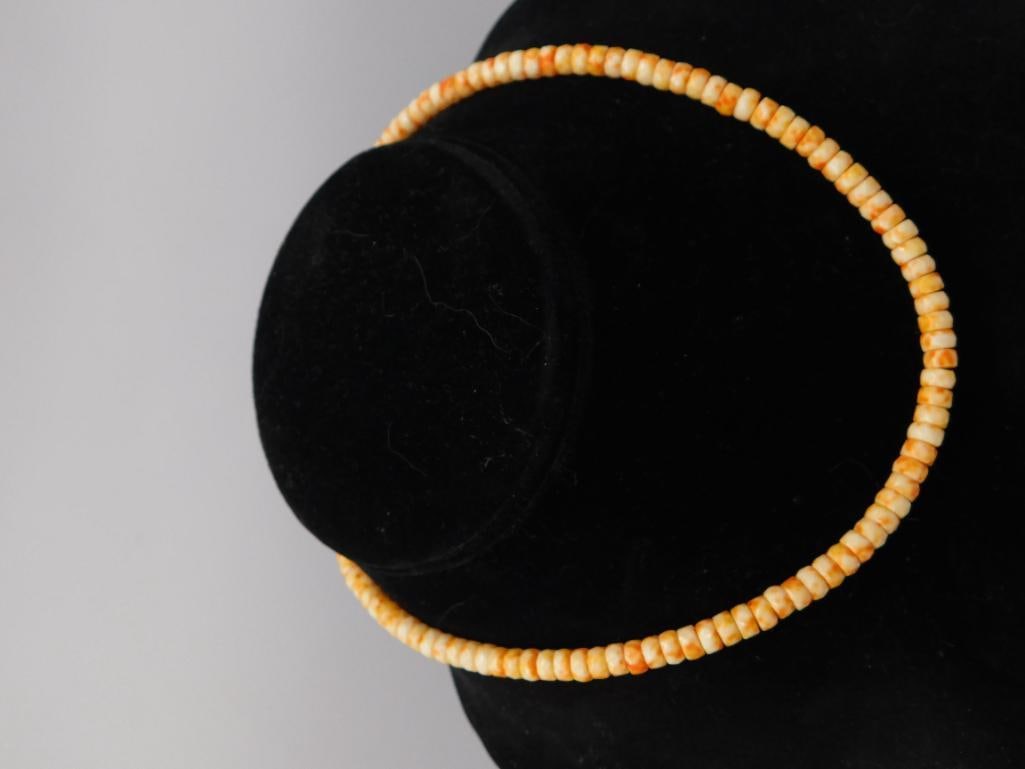 Coral or Shell Bead Choker Necklace: Single-strand rondelle bead necklace in mottled cream and orange tones, likely coral or dyed shell, displayed on a black velvet bust. Measures approximately 13-14 inches as shown against a ruler.