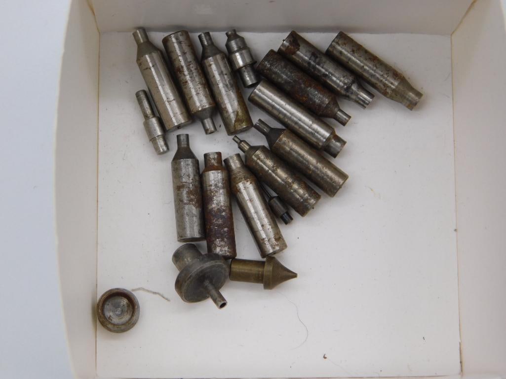 Watchmaker Collet and Bushing Tool Set, Boxed: A cardboard box containing approximately eighteen cylindrical collet and bushing tools with knurled and tapered ends. The set ranges from about half an inch to over an inch in length and shows