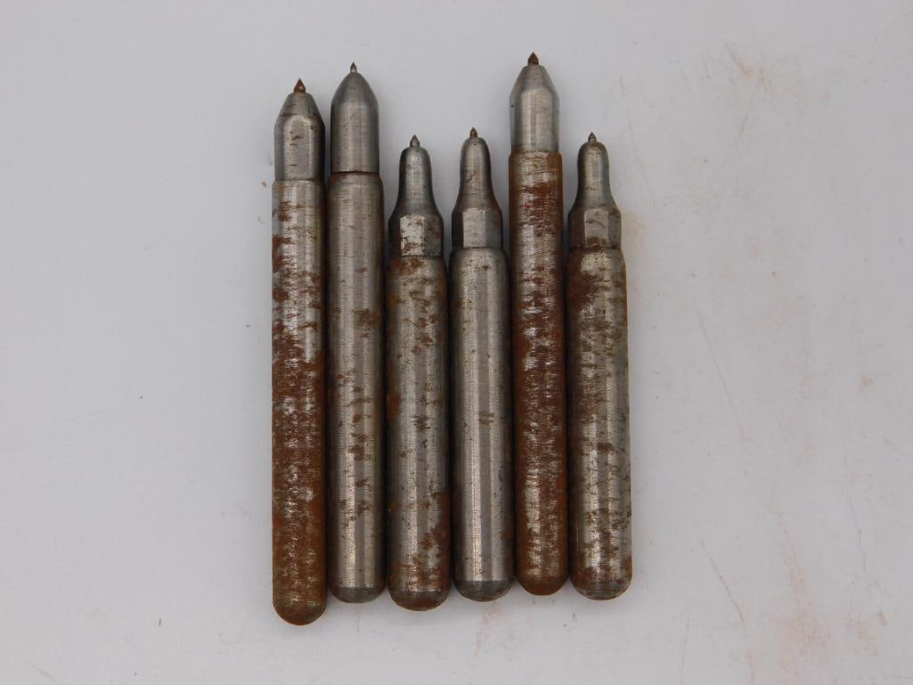 Watchmaker Staking Punch Set, Six Piece with Ruler: A set of six cylindrical steel staking punches with conical pointed tips, shown against a ruler confirming lengths of roughly two to three inches. The shafts show notable rust mottling while the tips