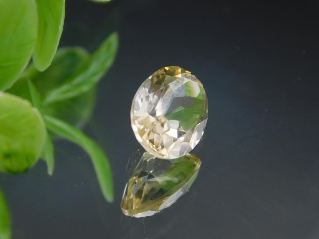 Oval-Cut Yellow Gemstone with Faceted Design Rock Stone Lapidary Specimen: Oval-Cut Yellow Gemstone with Faceted Design Rock Stone Lapidary Specimen