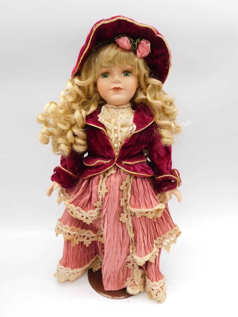 THE COLLECTORS CHOICE VINTAGE PORCELAIN DOLL WITH PINK DRESS AND RED COAT AND HAT: THE COLLECTORS CHOICE VINTAGE PORCELAIN DOLL WITH PINK DRESS AND RED COAT AND HAT