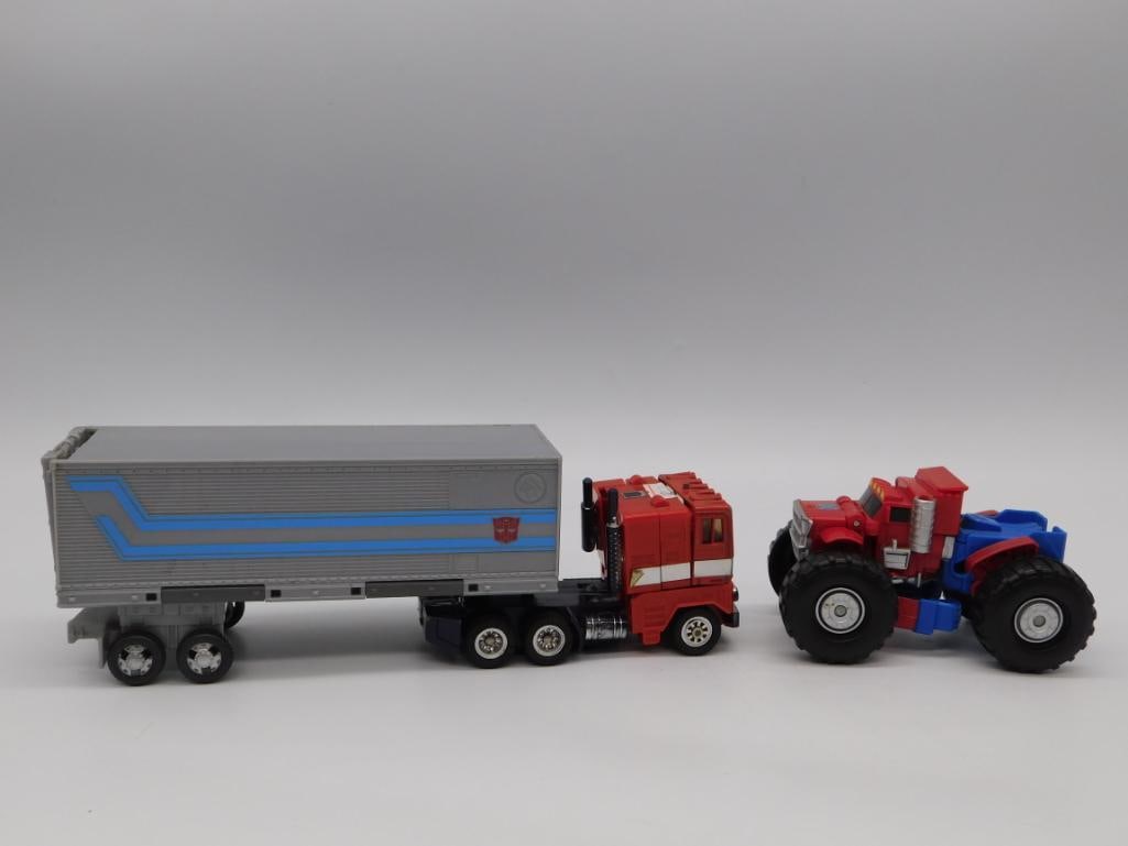 Vintage Transformers G1-Style Optimus Prime Semi-Truck Robot & Mini Figure: Two Optimus Prime-style Transformers robots: a larger red cab-over semi truck with detachable gray/blue trailer that converts into a robot, and a smaller Optimus Prime figure with monster-truck