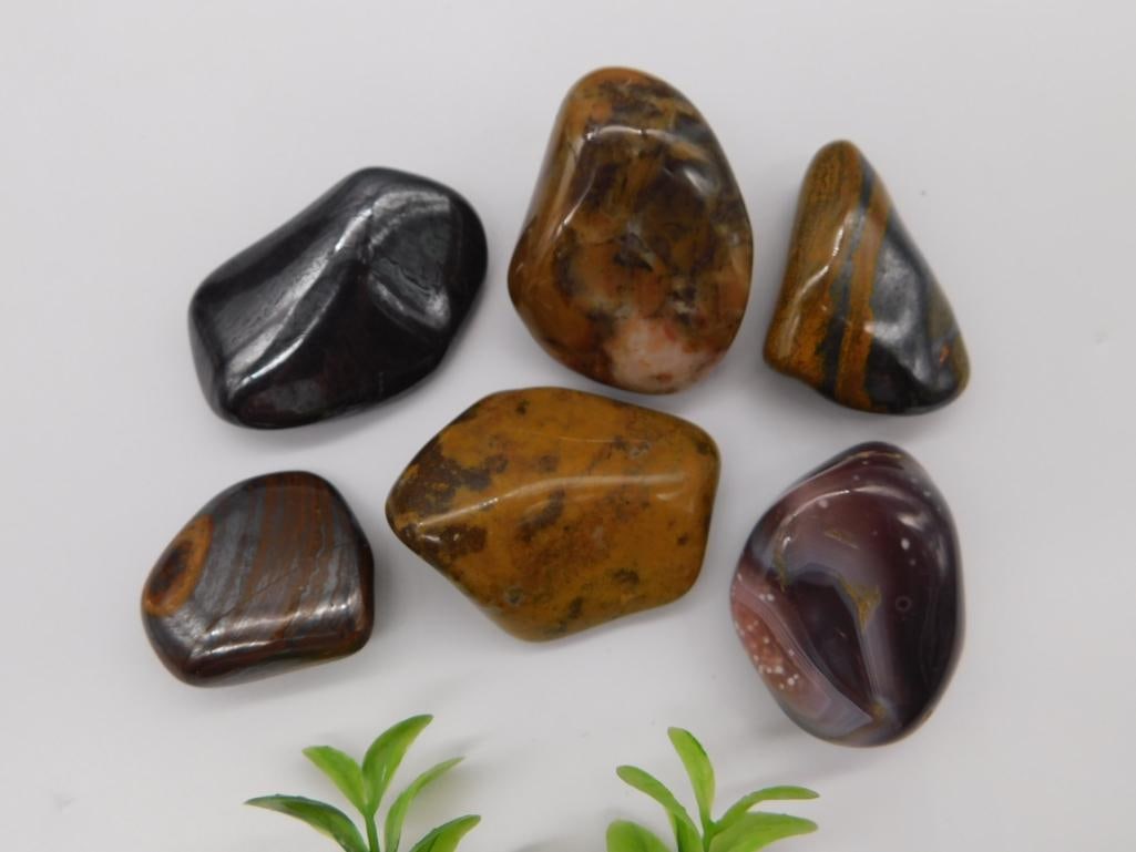 Polished Mixed Mineral Tumbled Stone Set: A set of six large polished tumbled stones including hematite, tiger's eye, agate, and jasper varieties in black, brown, orange, and purple tones. 178 grams.